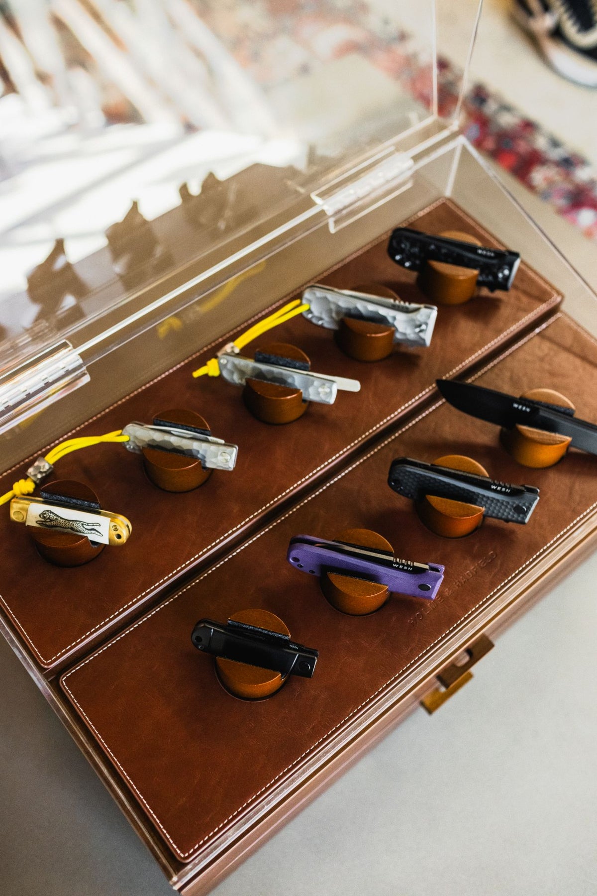 The Holme and Hadfield Armada case open, WESN knives on their pegs